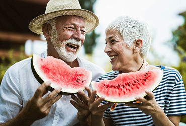 senior couple eating watermelon