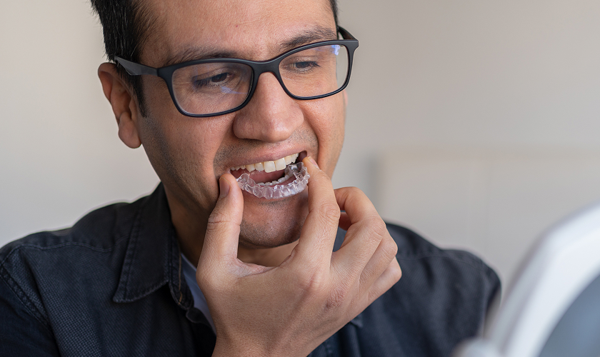 man putting in clear aligner