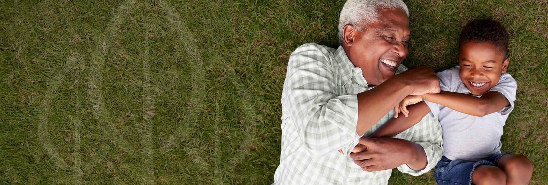 grandfather and grandson playing on the ground