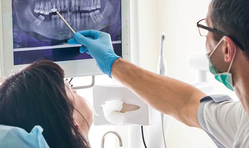 dentist showing patient x-ray
